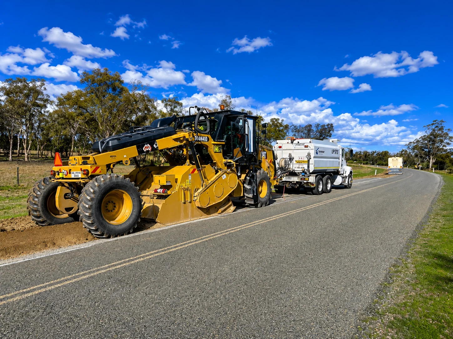 Road roller compacting pavement during restoration works